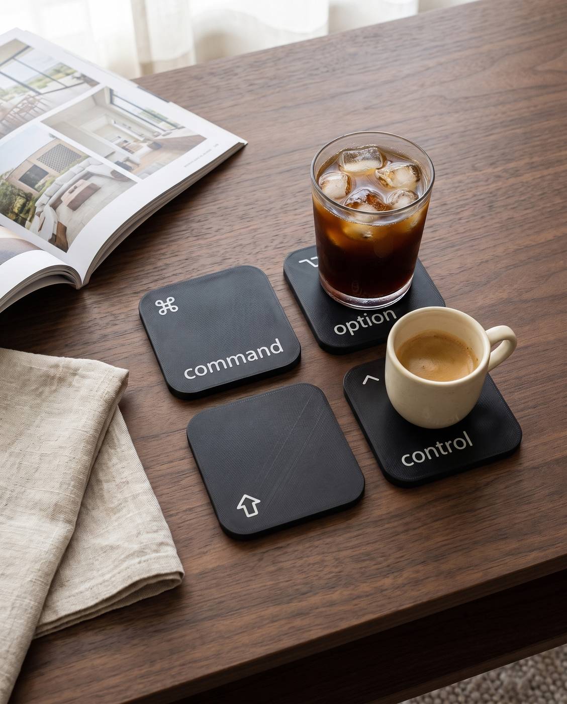 The four coasters on a walnut coffee table, an iced coffee on option and an espresso on control.